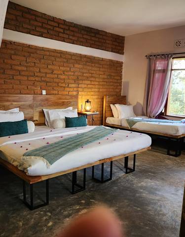 Interior of a room with two beds and wooden decor.
