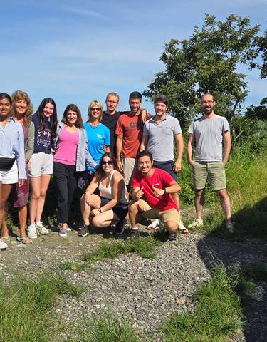 Group of travelers in a lush outdoor setting.