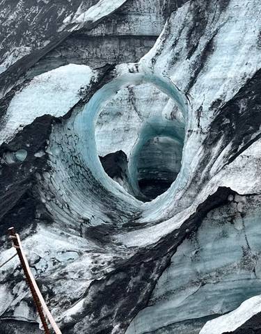 An ice cave with intricate patterns of light and shadows.