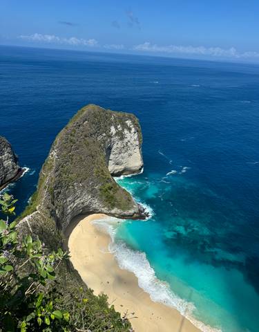 Cliff formation by the ocean with turquoise waters.