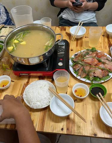 Traditional Vietnamese hotpot meal setup.