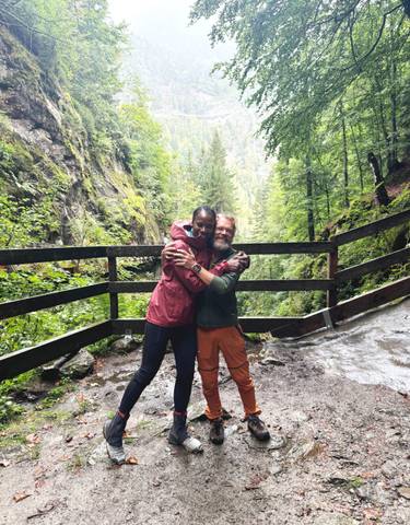 Happy couple embracing in a lush green forest.