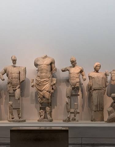 Ancient Greek sculptures on display in a museum.