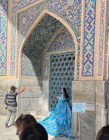 Decorated entrance to a historical building with two people.