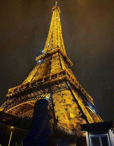 Illuminated Eiffel Tower against the night sky.