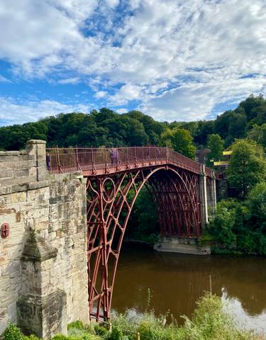 Historic iron bridge over a river.