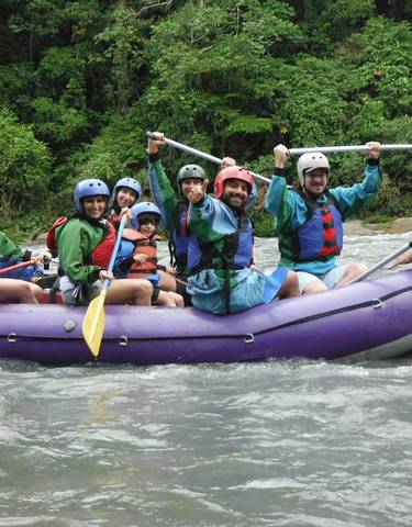 Group of people in a raft enjoying white-water rafting.