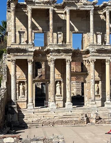 Ancient Roman library ruins with statues.