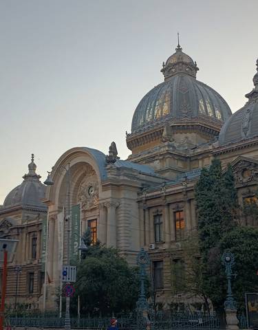 Imposing historical building with domes and arched entrance.