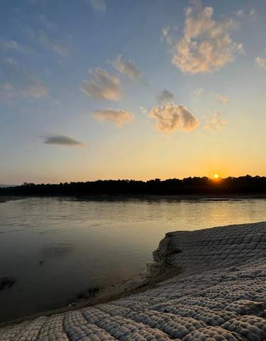 Serene sunset over a river landscape.