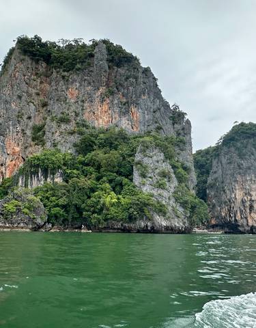 Dramatic rocky cliffs rising from the sea.