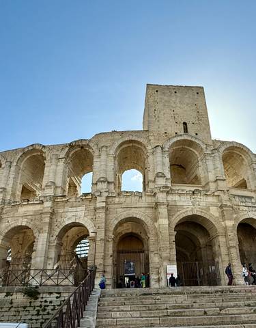 Historical stone amphitheater under a clear blue sky.