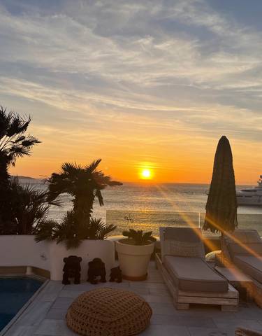 Sunset view overlooking a marina with yachts.