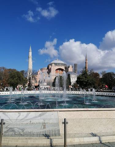 Fountain in front of the magnificent Hagia Sophia under a clear sky.