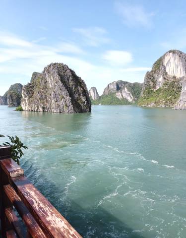 Limestone karsts in a bay with calm blue waters