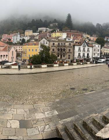 Foggy view of a town with colorful houses.