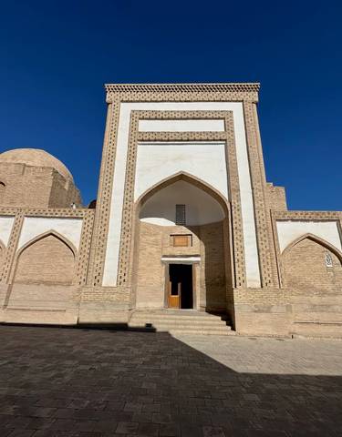 Historic building with distinctive arches and intricate brickwork.