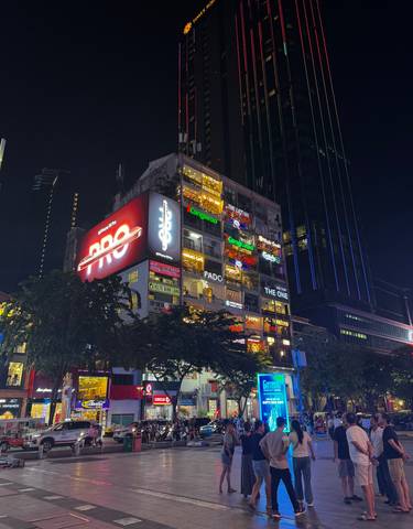 Building with bright neon signs at night.