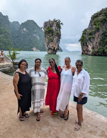 Group of women posing with James Bond Island in the background.