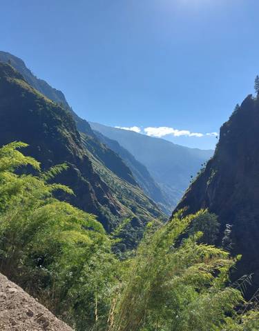 Scenic mountain valley with lush vegetation.