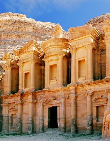 The iconic Al-Khazneh facade carved into a sandstone cliff.