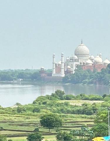 View of the Taj Mahal from a distance across a river.