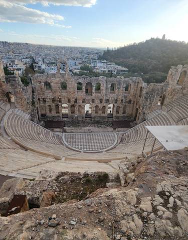 View of Herodion Theatre with city in background.