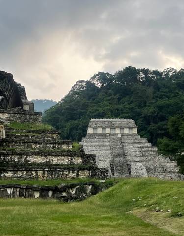 Ruins of an ancient stone temple surrounded by jungle.