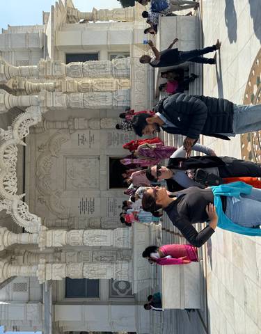 Tourists gathered in front of a grand temple facade.