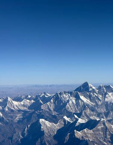 Snow-capped mountains under a clear blue sky.