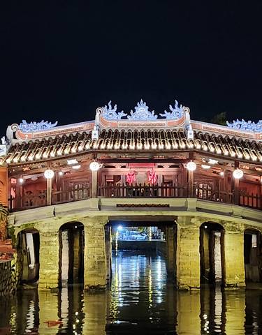 Japanese bridge illuminated at night.
