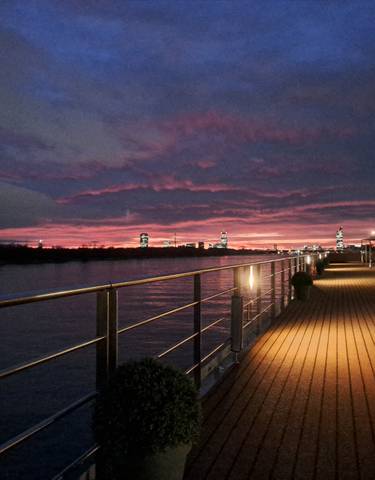 Sunset view from a deck overlooking a river.