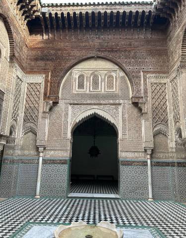 Ornate entrance of a Moroccan building with detailed designs.