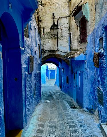 A narrow, winding street painted in bright blue.