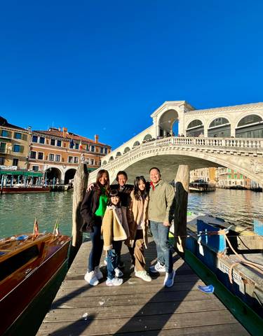 Group posing in front of the Rialto Bridge.