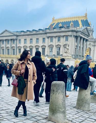 People standing in front of a historic palace entrance.