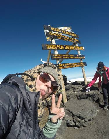People celebrating at the summit of Mount Kilimanjaro.