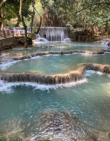 Multilevel waterfalls with turquoise water cascading down.