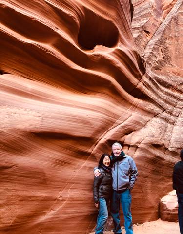 Couple posing in front of red sandstone formations.