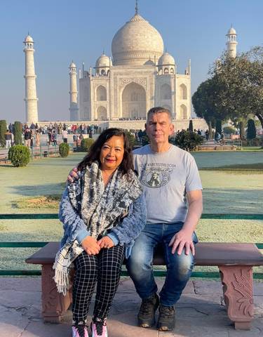 Couple sitting in front of the Taj Mahal.