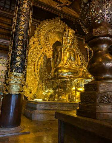 A golden Buddha statue inside a temple.