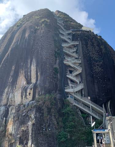 A large rock formation with a staircase in the middle.