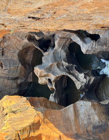 Aerial view of Bourke's Luck Potholes with swirling water patterns.