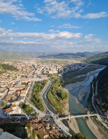 Aerial view of a city with mountains in the background.