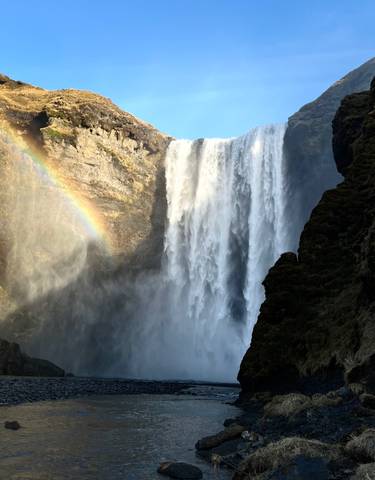 Powerful waterfall with rainbow in the spray.
