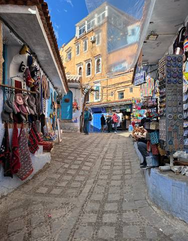 Colorful street market with various items on display.