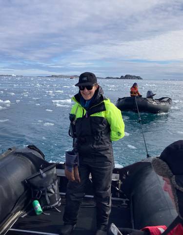 People on inflatable boats in icy water, Antarctica.