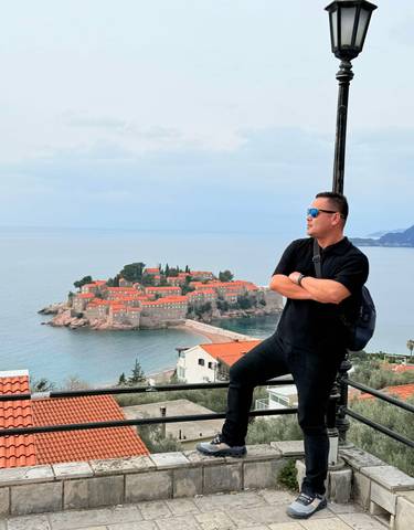 Tourist overlooking a coastal islet.