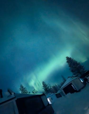 Aurora Borealis over a snowy landscape.