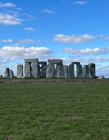 The iconic stone circle of Stonehenge under a clear sky.